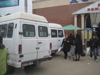 Marshrutkas in Bishkek displaying bus ID, e.g. B33-80G, in their rear windows.