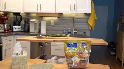 The dining table with the back lifted to serve as additional counter space and for easier access to larger stored items.